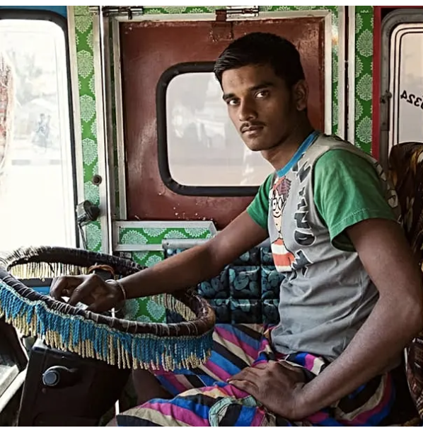 Rajan Verma, truck driver from Rajasthan, sits at the wheel of his decorated truck